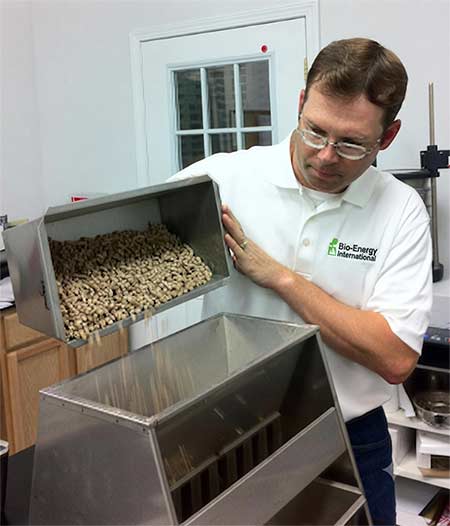 A biomass lab manager testing wood pellet moisture content