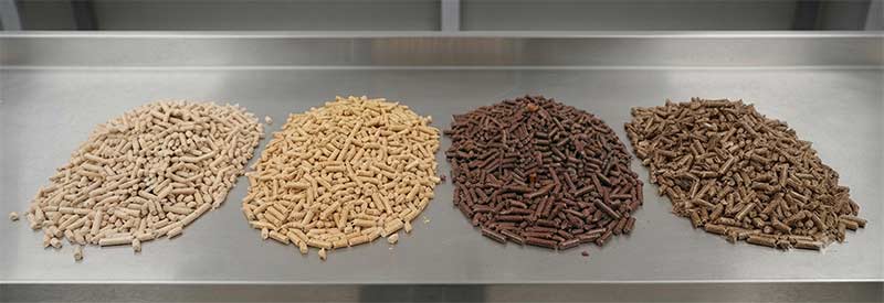 Wood pellets ranging in color from pale blonde to reddish-brown