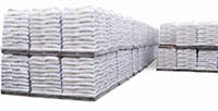 Shrink-wrapped one-ton skids of wood pellets stored in a yard