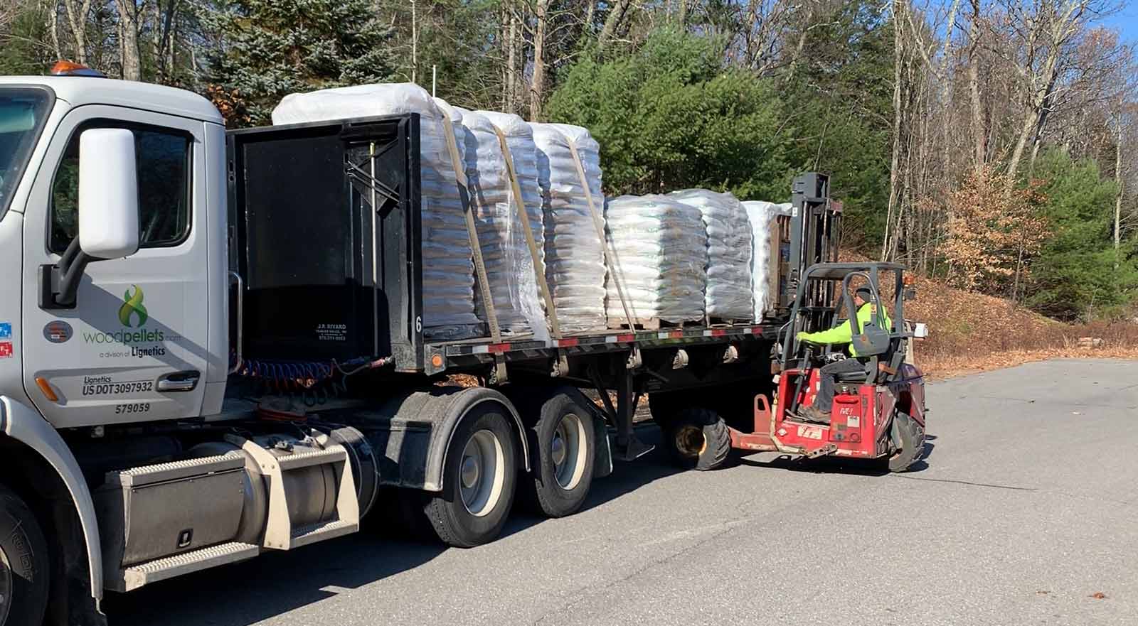 WoodPellets.com delivery truck being unloaded by a forklift